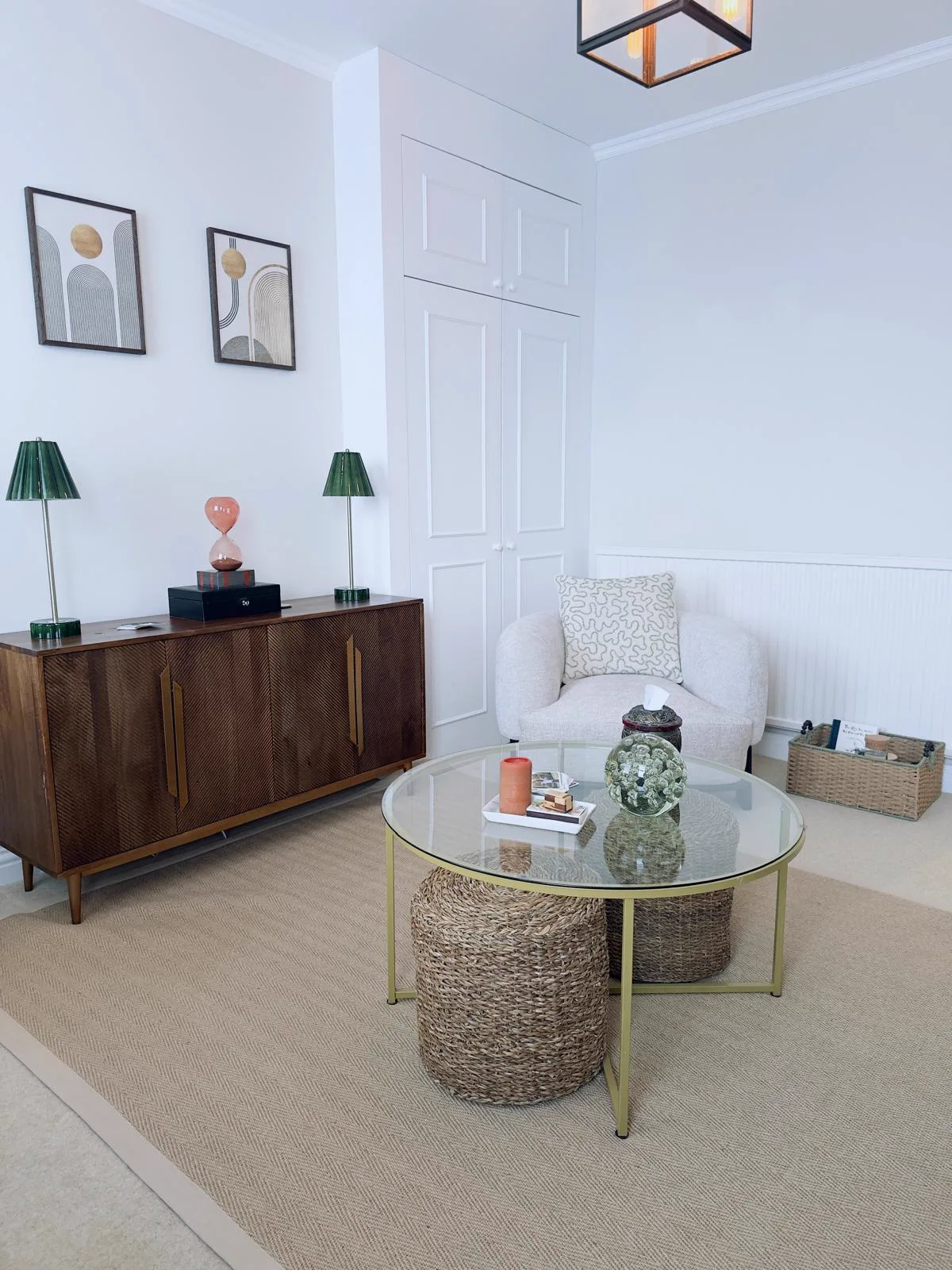 Close-up of the therapy room seating area with glass coffee table and woven textures at Wainwright Family Support